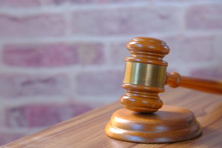 Close up of gavel, book and handcuff on tableの写真素材