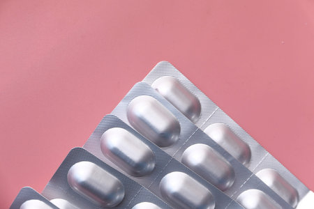 top view of blister pack pink background