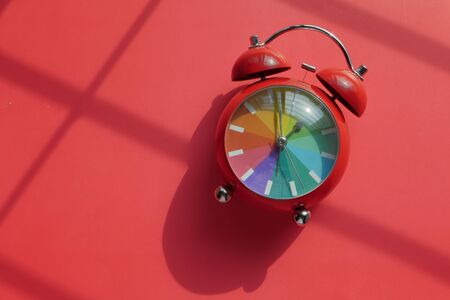 red color alarm clock on red background, top viewの写真素材