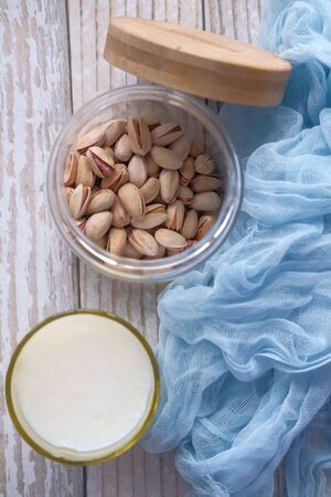 Dairy products. nut and glass of milk on wooden table.の写真素材
