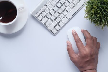 man hand use computer mouse on white background.の写真素材
