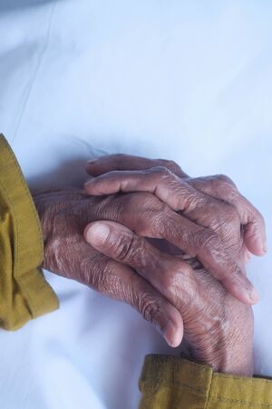 close up of senior women hand on table.の写真素材