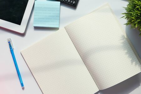 open notepad, digital tablet on table at early morningの写真素材