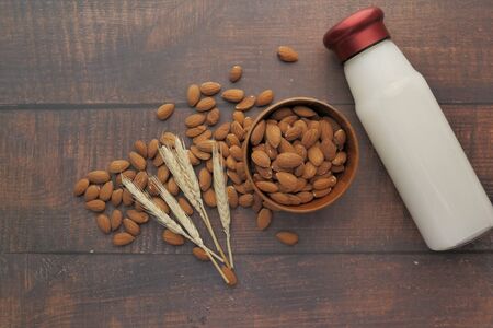 raw almond glass of milk on wooden table.の写真素材