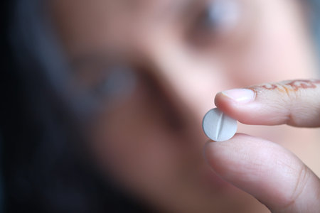Close-up shot of pill in nurses hand