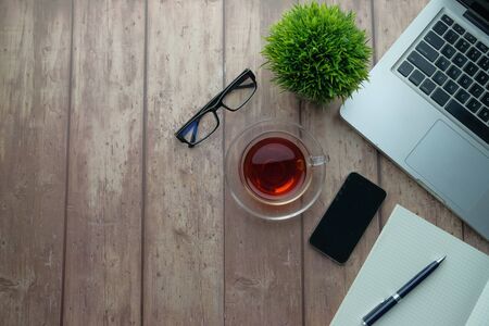 office desk table with laptop, smartphone and supplies. Top view, flat lay.の写真素材