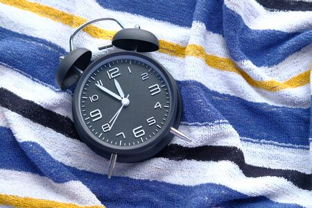 black vintage alarm clock on towel.の写真素材
