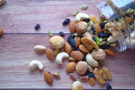 top view of mixed nut spilling on table.