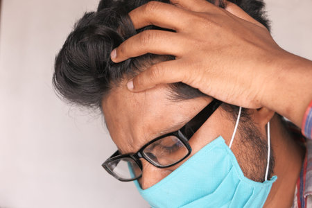 a frustrated man with a mask on his face for antivirus protection