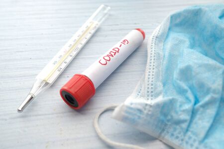 Close up of blood test tubes, face mask, Blood positive test to coronavirusの写真素材