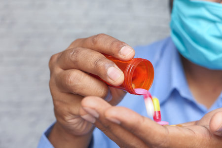a frustrated man with a mask taking medicine