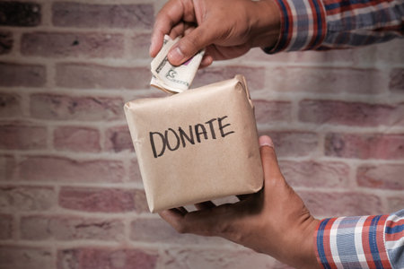 Donation Concept. man holding a Donate Box for Giving