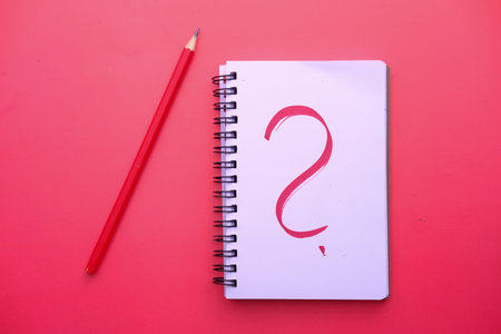 The text WHY on white paper on red background .の写真素材