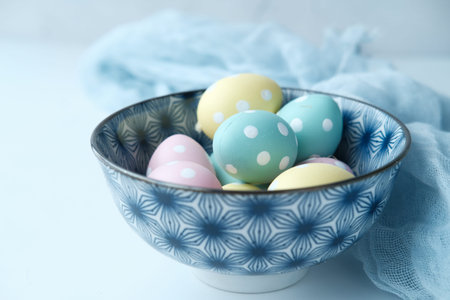 top view of easter eggs in a bowl on white background .