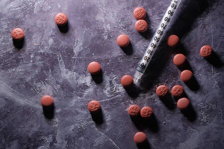 Assorted medical drugs and syringe on tableの写真素材