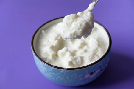 bowl of fresh yogurt on table, close up.の写真素材