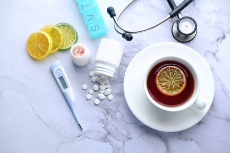 high angle view of lemon tea and pill on table.の写真素材