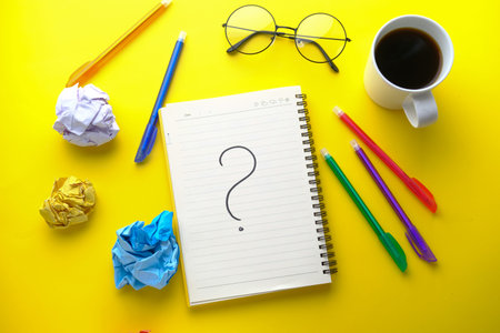 high angle view of question mark on notepad