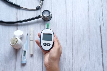 high angle view of women holding diabetic measurement toolsの写真素材