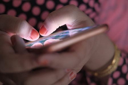 Close up of women use smart phone at night.