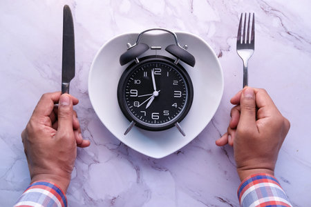 high angle view of clock on plate on wooden table