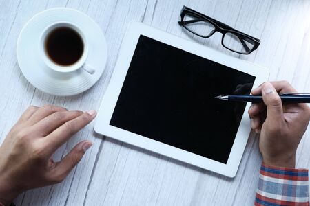 young man using digital tablet on tableの写真素材