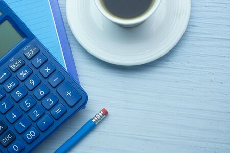 calculator, notepad and tea on wooden table .の写真素材