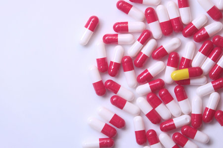 close up of capsules spilling form container.