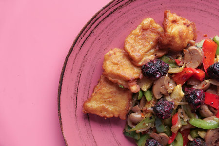 Fried chicken nuggets and salad on plate .