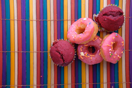 Close up of colorful donuts on wooden table.の写真素材