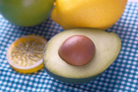 Close up of fresh avocado with fruits on table .
