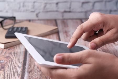 Woman pointing on digital tablet screen, close up
