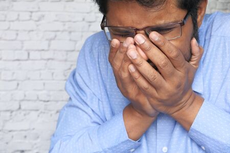 Young ill man have a cough and sore throat.の写真素材