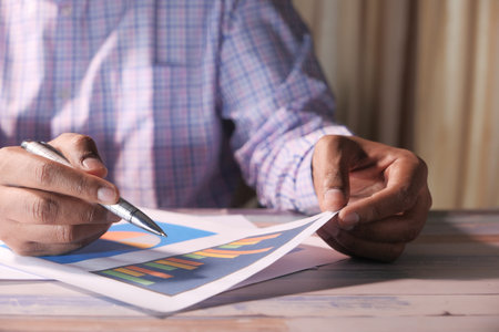 businessman analyzing working on office desk, top viewの写真素材