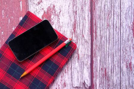 pencils, notebook and smart phone on table.の写真素材