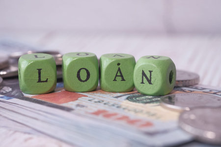 loan text, coins and cash on table.