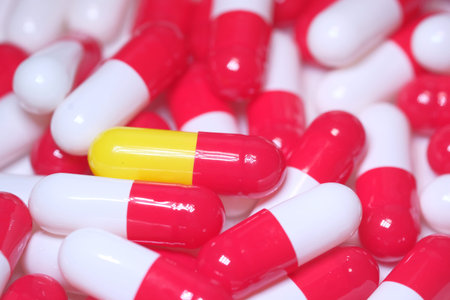 close up of colorful capsules, health and medical concept