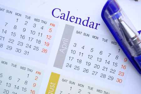 close up of calendar and pen on table