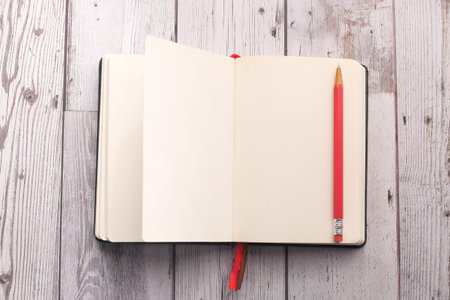 high angle view of notepad with pen on tiles background