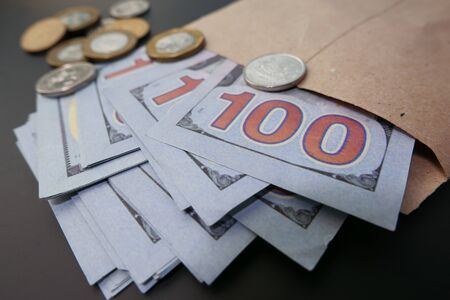Close up of 100 dollar cash in envelope.の写真素材