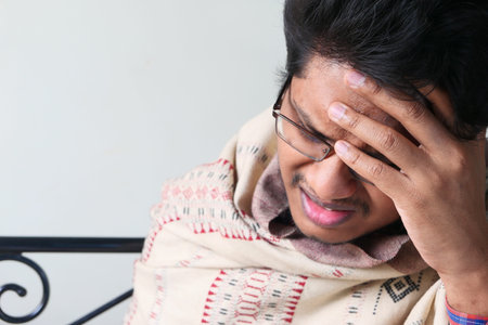 A sick man suffering headache, close up