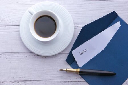 high angle view of envelope, letter and tea on table.の写真素材