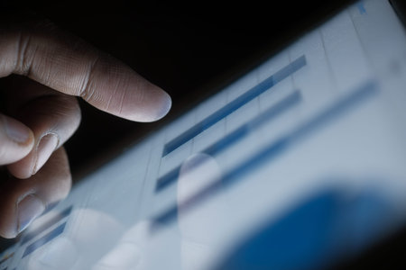 person hand analyzing financial data in digital tablet