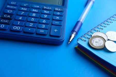 empty notepad with pencil and calculator wooden backgroundの写真素材