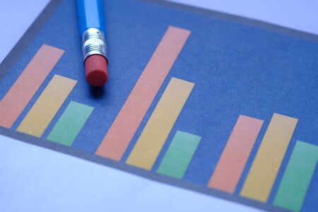 close up of bar chart and pencil on paperの写真素材