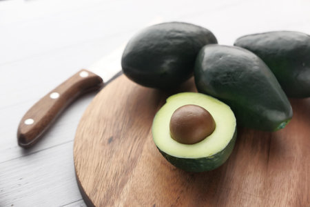 Close up of fresh avocado on chipping board.