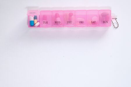 Top view of medicine in a pill box on white.の写真素材