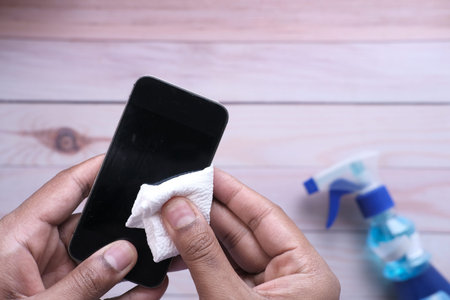 close up of person hand cleaning smart phone.