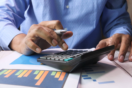 person hand using calculator on offie desk