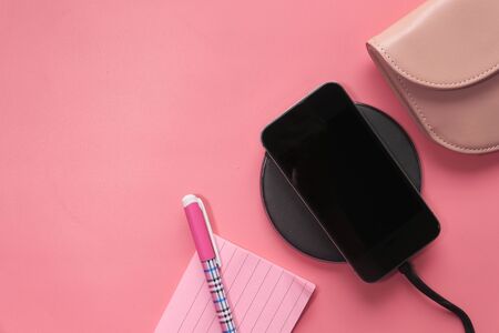charging Smartphone Using Wireless Charging Pad, top viewの写真素材